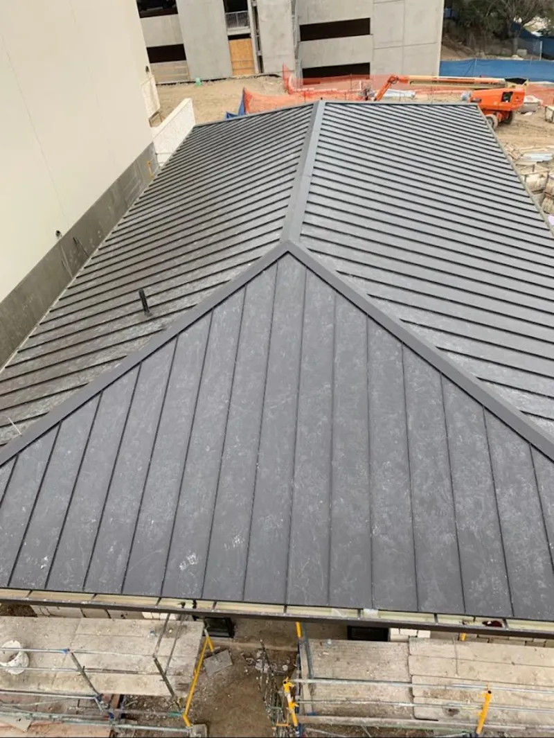 Commercial metal roof construction with crane equipment in Jupiter Farms