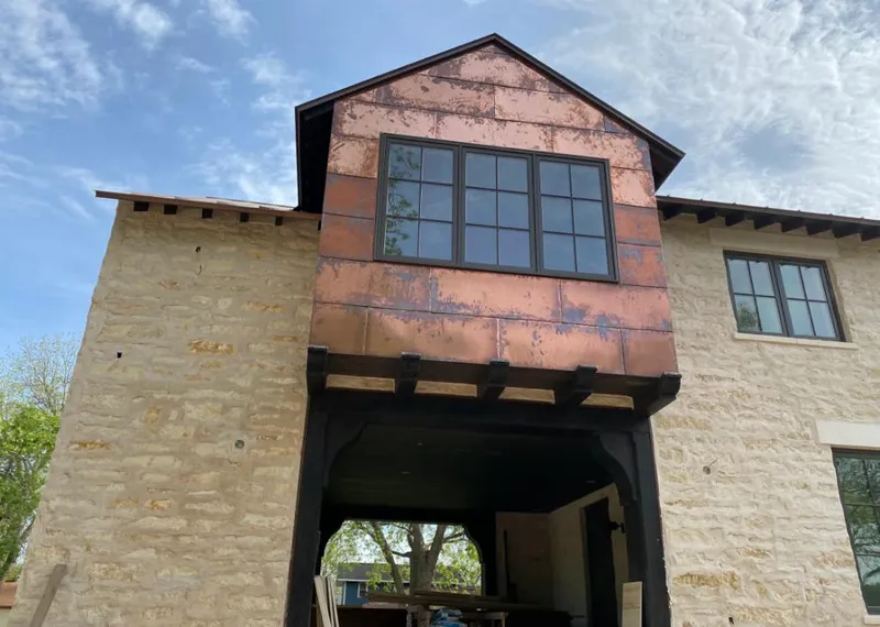 Copper metal panel facade on a stone building for Roof Repair in Jupiter Farms