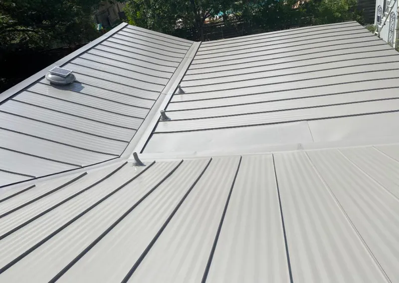Solar attic fan installed on a metal roof for Roof Ventilation in Jupiter Farms